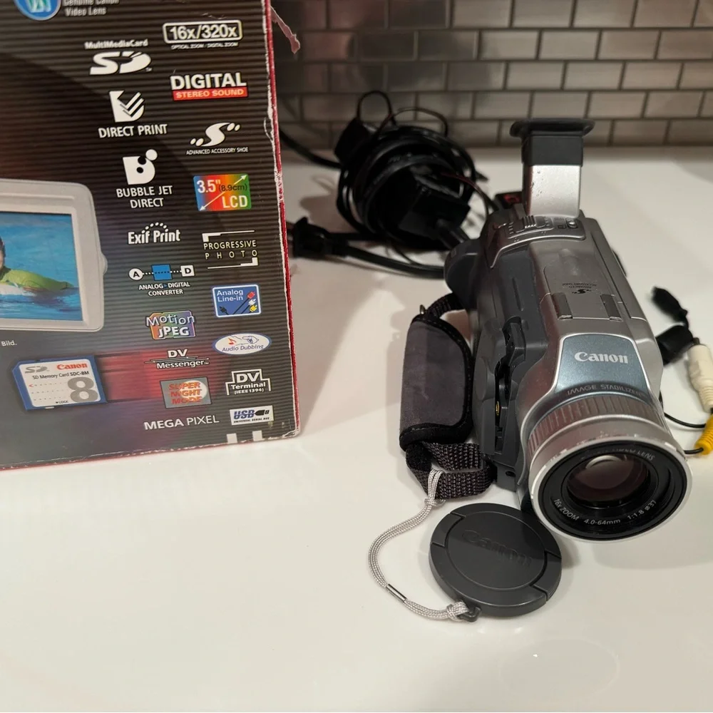 Canon Silver Compact Camcorder with Lens Cap and Cables
